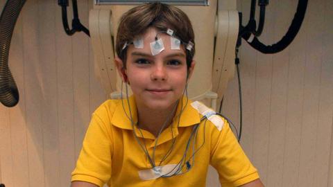 Boy with sensor pads on his head