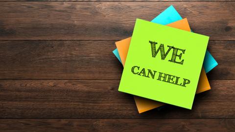 Sticky note that says "We Can Help"