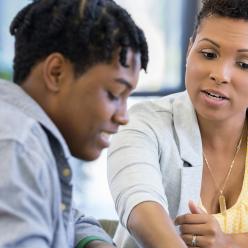 Woman tutoring young man