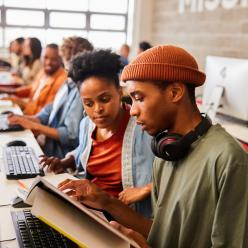 Two college students working together at a computer