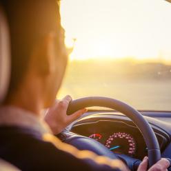A man behind the wheel of a car