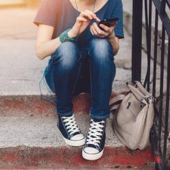 Legs and feet of girl sitting on steps