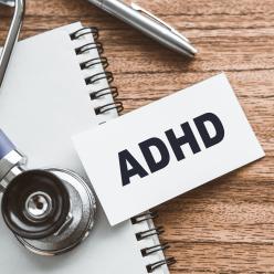 stethoscope, notepad, pen, and ADHD printed on a card