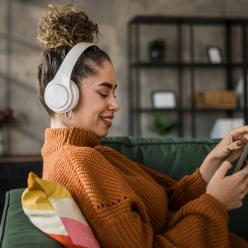 Young adult listening to an audiobook on her phone.