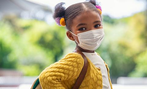 Little girl wearing a mask
