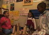 Three children playing with blocks.