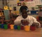 girl playing with multicolored cups.