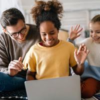 Father with two daughters at computer