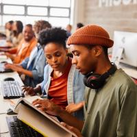 Two college students working together at a computer